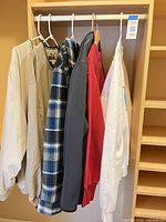 All six tops hanging on closet rod