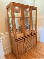 Front view of oak glass display cabinet