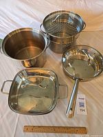 Overview of all four cookware bodies with two lids visible