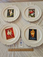 Group shot of all four decorative plates with ruler for scale