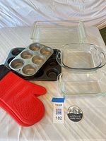 Group shot of all glass dishes, muffin pans, and oven mitts