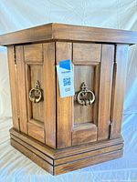 Closed view showing paneled doors and brass hardware