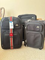 All three Samsonite suitcases standing together