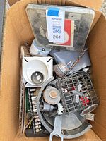 Top view of cardboard box showing mix of blades, hole saws, drill bits and accessories