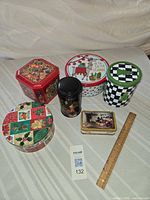 Overview of six visible tins with ruler for scale