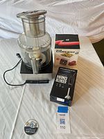 Whole lot showing Cuisinart food processor with attachments, boxed Ovente immersion blender and boxed 16 lb kitchen scale