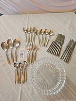 Full view of entire flatware set and glass bowl