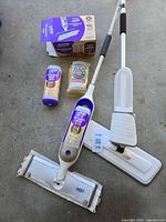 Overview of Swiffer mop, cleaning solutions, replacement pads and extra mop head