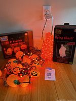 Box of 50 ct pumpkin curtain lights, flying ghost prop box, lit pumpkin lights, orange rope light coil