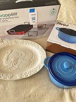 All three items: boxed Servappétit roasting pan with rack, boxed Parini casserole, ceramic turkey platter