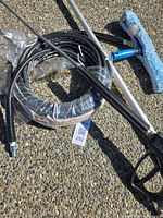 Overall kit: coiled hose, telescopic pole, pressure gun, squeegee head