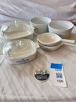 Group shot of all cookware items including casseroles with lids, handled pans, soufflé dishes