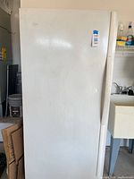 Front view of closed white Whirlpool upright freezer