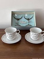 Cup and saucer pairs with boxed champagne glasses visible