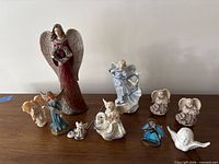 Group shot of all angel figurines arranged on table