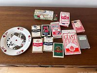 Dresser top with entire lot in view: poker chip box, plate, multiple card decks, giant deck