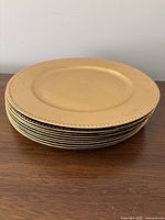 Stack of gold chargers showing rim detail