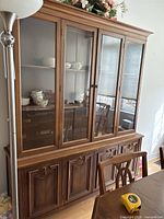 Full view of wood china cabinet showing glass hutch and base