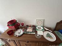 All items on sideboard showing plates, platter, cake server, goblets, bowl, baskets and linens