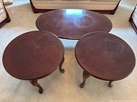 Set overview showing oval coffee table and two round side tables