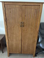 Front view of closed pine cabinet