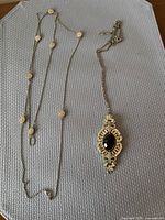 Both necklaces laid out showing overall design and length