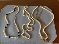 All three faux pearl necklaces displayed side by side