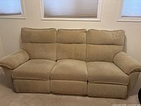 Front view of beige three-seat sofa upright