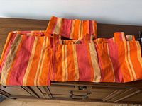 Three cotton striped pieces laid out showing pattern and rod pockets