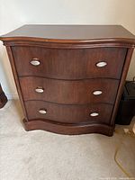 Front view of dresser showing three drawers and pulls