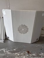 Table body folded with decorative silver stencil visible