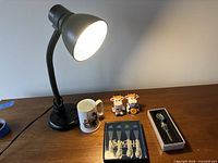 Lot overview showing lamp, mug, cow shakers, Seagull Pewter spreaders, bottle stopper