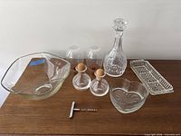 Group shot of all glass items and corkscrew on table