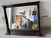 Front view of mirror showing entire wooden frame and reflective surface