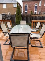 table with six matching chairs on deck