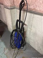 Front view of Simoniz pressure washer showing hose and wand