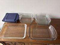 Six glass dishes displayed on table