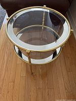 Oblique top view showing glass top shelf, brass frame and legs