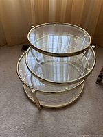 Overall view of three-tier glass and chrome swivel side table