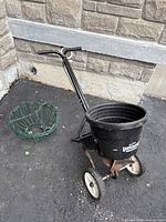 Seed spreader and one hanging basket on driveway