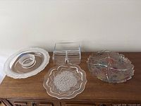 Four glass serving pieces on wooden surface