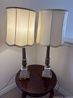 Both lamps displayed on table, shades illuminated