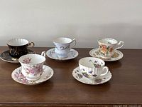 Group of five teacup and saucer sets