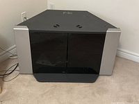 Front view of Sony TV stand with closed smoked glass doors