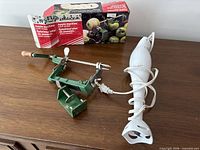 Lot overview showing apple peeler-corer with box and Chefman immersion blender