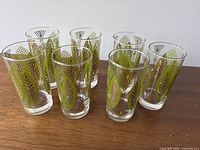 Six tumblers on wood surface showing pattern and size