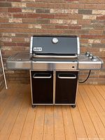 Front view of closed Weber Genesis grill on deck