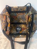 Front view showing patchwork fabric, straps and Bali label
