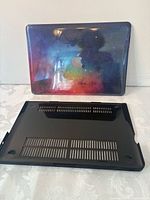 Galaxy print top cover still in plastic wrap, black vented bottom cover displayed