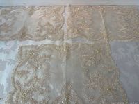 All four ivory organza lace placemats laid out showing overall design